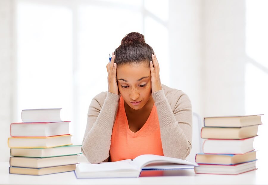 Anxious teen girl doing homework