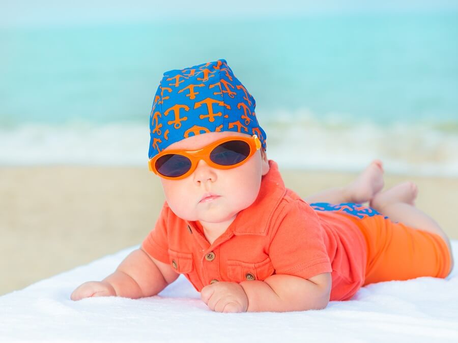 Baby wearing sunglasses at the beach