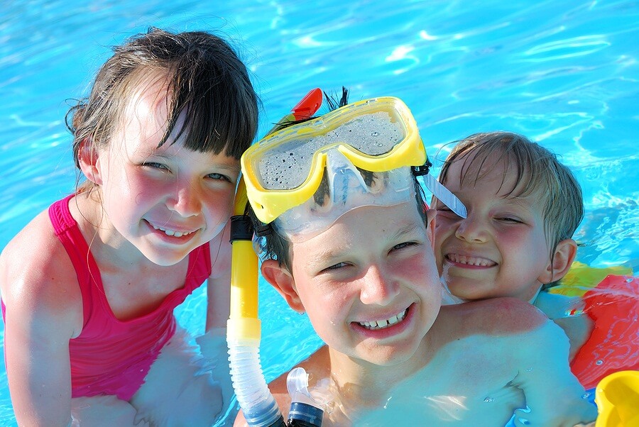Group of kids smiling in pool