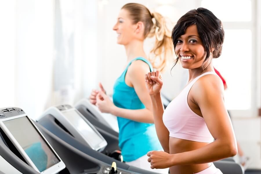 Happy woman running on treadmill