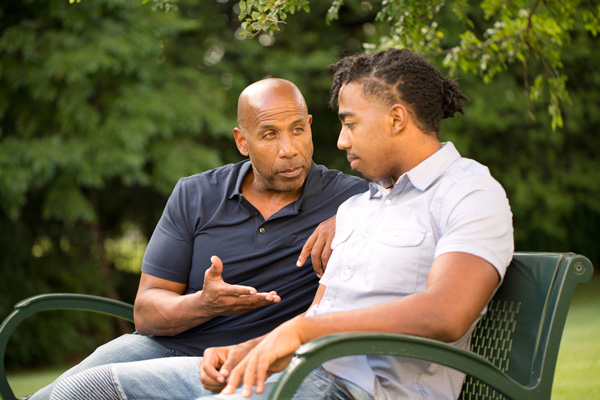 Dad and son with chronic illness having a serious conversation