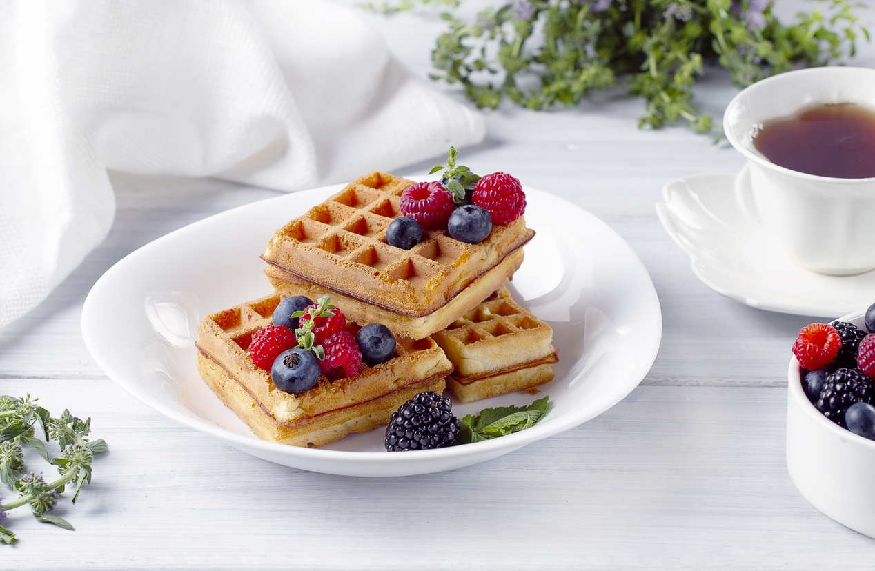 Viennese waffles, with berries, on a white table